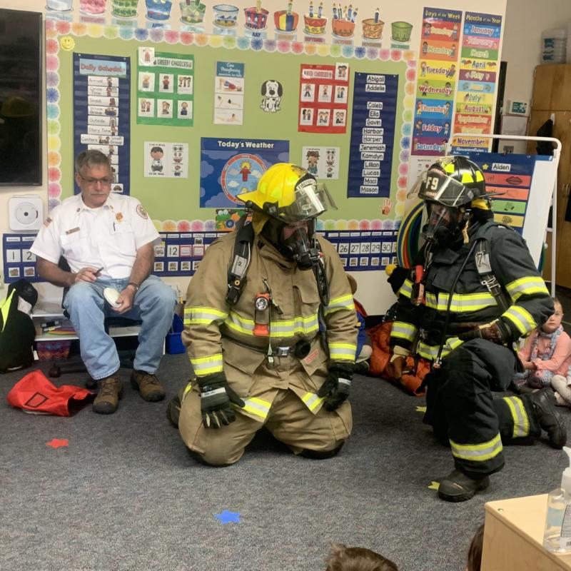 Lt. Chantelle Arsenault and Tyler Lowery show students what a fully dressed firefighter looks like Oct. 11 during a fire safety demonstration at BRES. BILL PEARSON/Boothbay Register