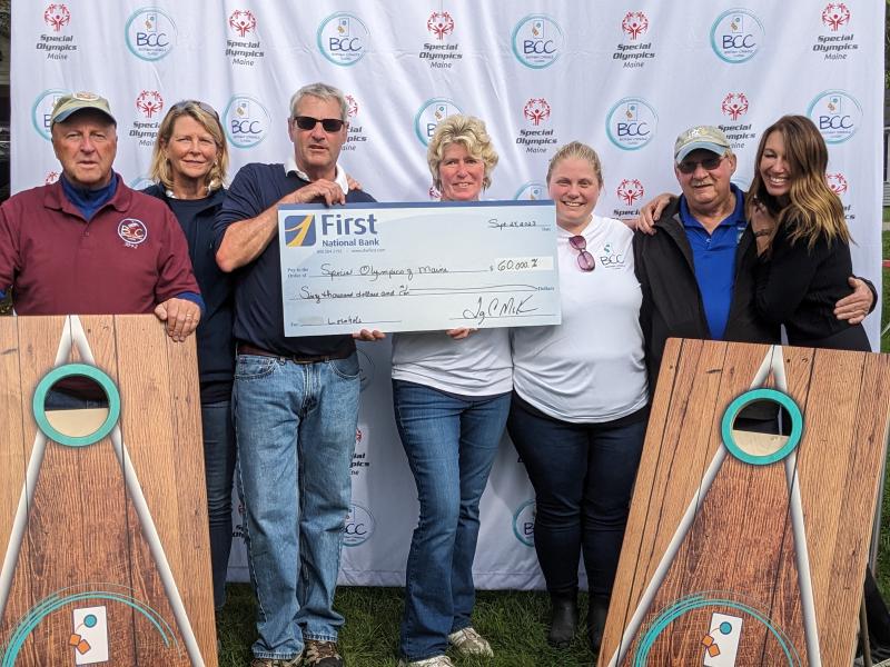Members of the Boothbay Classic Cornhole team hold a mock check for Special Olympics Maine. CANDI JONETH/Boothbay Register
