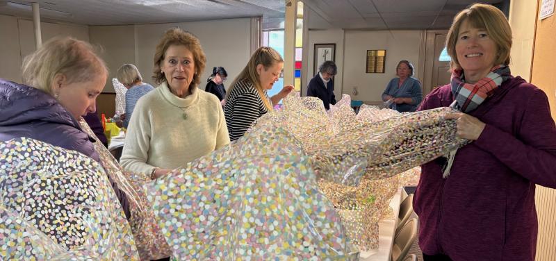 Sarah Giles, center, assists two church volunteers in preparing Easter baskets at East Boothbay United Methodist Church. Courtesy photo basket3