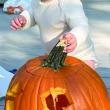 A child and a pumpkin