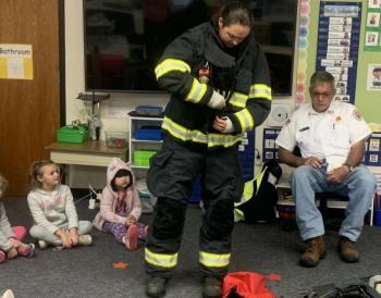 Lt. Chantelle Arsenault is almost ready to put on her mask and air tank Oct. 11 during a fire safety demonstration at BRES. BILL PEARSON/Boothbay Register