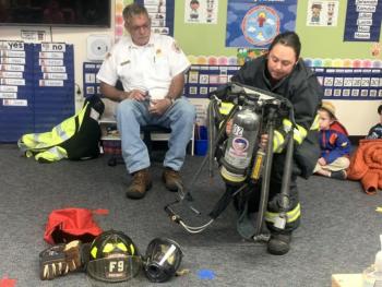 Lt. Chantelle Arsenault assembles her air tank Oct. 11 during a fire safety demonstration for BRES students. BILL PEARSON/Boothbay Register