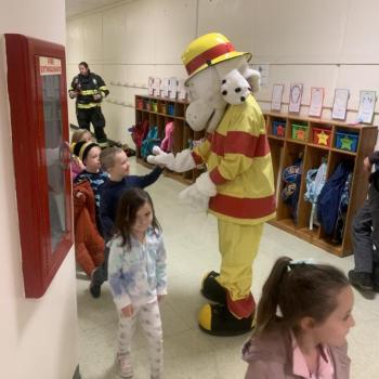 Boothbay Fire Department mascot Sparky receives a round of “a paws” following a fire safety demonstration by Fire Chief Dick Spofford, Lt. Chantelle Arsenault and fireman Tyler Lowery. BILL PEARSON/Boothbay Register