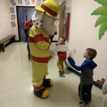 Sparky asks a pre-kindergarten student to show him his paw. BILL PEARSON/Boothbay Register
