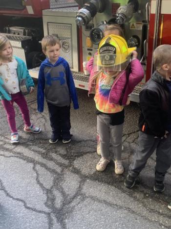 The fire helmet is still a “little” big for this BRES pre-kindergartener. BILL PEARSON/Boothbay Register