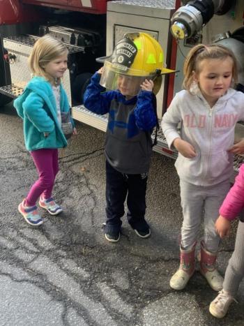 Pre-kindergartener Angus Kaler looks like a future firefighter during a Boothbay-Boothbay Harbor fire department visit to BRES on Oct. 11. BILL PEARSON/Boothbay Register