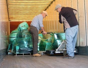On the truck loading the pallets are Dick Rogers, left, of Gardiner and truck driver Steve Lee from Wilton. STEVE EDWARDS/Boothbay Register Loading