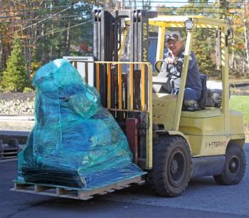 Russ Pinkham gets ready to load a pallet of supplies onto the truck. STEVE EDWARDS/Boothbay Register Russ on the forklift