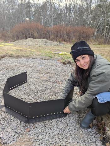 Program Manager Misha Barker sets up a firepit for BRES's new outdoor classroom. Courtesy of Erin Quinley Program Manager Misha Barker sets up a firepit for BRES's new outdoor classroom. Courtesy of Erin Quinley