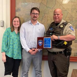 Lt. Brendan Kane receives the 2021 “Deputy of the Year” award July 5 during the commissioners’ meeting. He was joined by his children, Riley and Griffin Kane, who surprised him by attending the ceremony. Courtesy photo