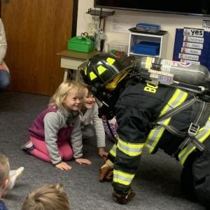 A couple BRES pre-kindergarteners get a closer look at Boothbay Lt. Chantelle Arsenault Oct. 11 during the Boothbay-Boothbay Harbor fire departments’ annual visit to the lower grades. BILL PEARSON/Boothbay Register